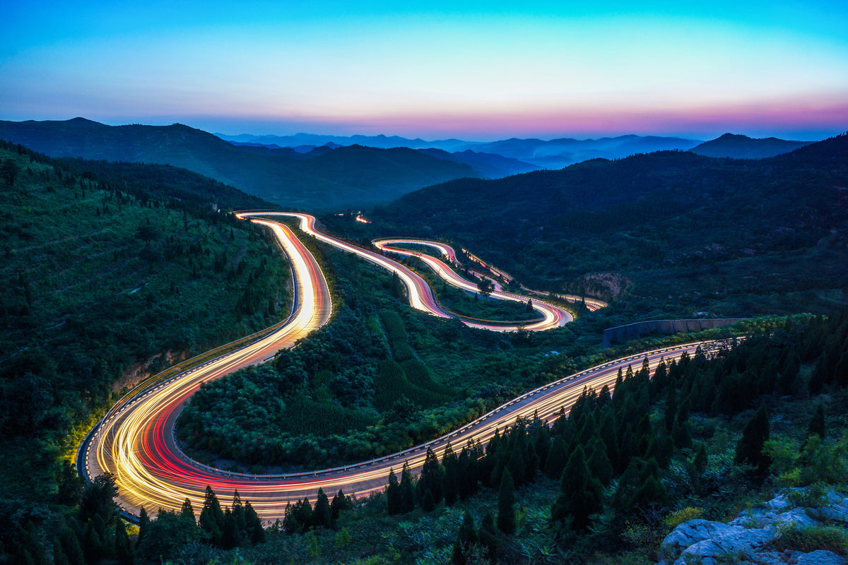 photo-wallpaper-winding-mountain-road-with-light-trails-at-blue-hour
