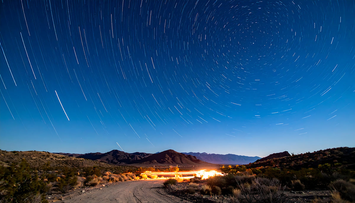photo-wallpaper-star-trails-over-a-desert-track-under-deep-blue-night-sky