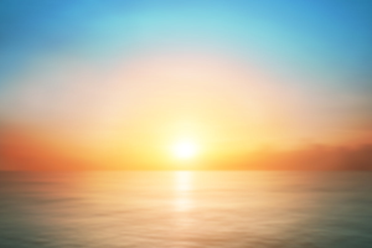 photo-wallpaper-sunrise-over-a-calm-sea-with-soft-glowing-light