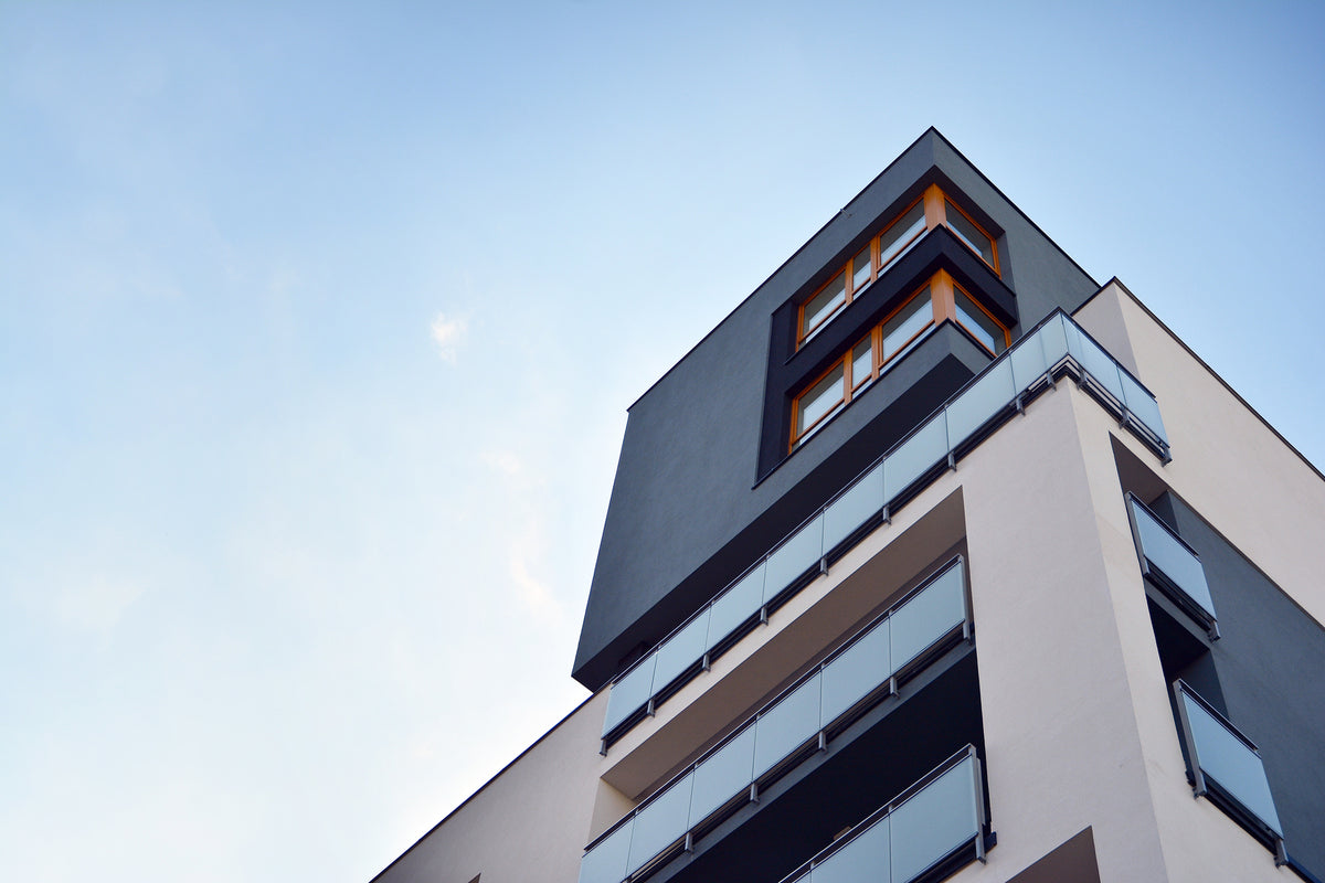 photo-wallpaper-building-corner-with-glass-balconies-against-a-clear-blue-sky