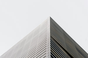 photo-wallpaper-building-corner-with-louvred-facade-against-a-white-sky