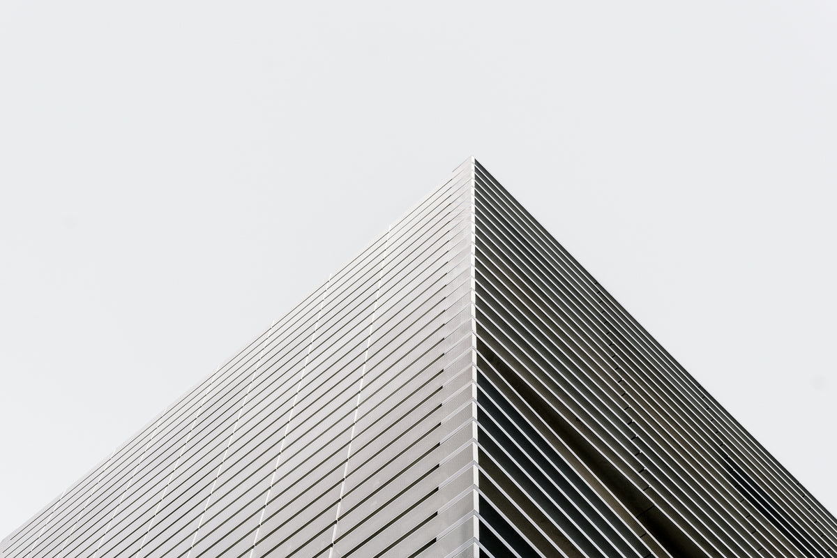 photo-wallpaper-building-corner-with-louvred-facade-against-a-white-sky