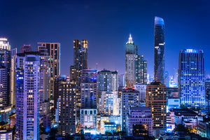 photo-wallpaper-glowing-skyscrapers-at-blue-hour-sparkling-city-skyline
