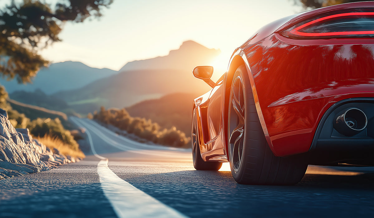 photo-wallpaper-red-sports-car-on-a-mountain-road-in-golden-evening-backlight