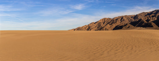 photo-wallpaper-rippled-desert-sand-beneath-a-bare-mountain-ridge