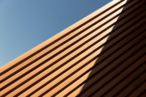 photo-wallpaper-diagonal-timber-slats-against-a-blue-sky-with-a-sharp-shadow-line