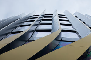 photo-wallpaper-curved-metal-facade-soaring-into-a-pale-sky