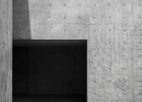 photo-wallpaper-exposed-concrete-wall-with-dark-passage-and-sharp-shadows