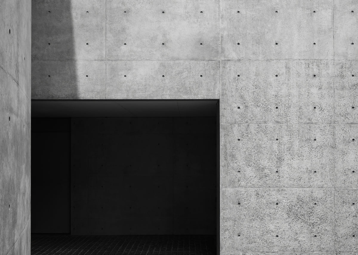photo-wallpaper-exposed-concrete-wall-with-dark-passage-and-sharp-shadows
