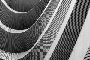 photo-wallpaper-curved-wooden-slats-sweeping-across-a-facade-in-black-and-white
