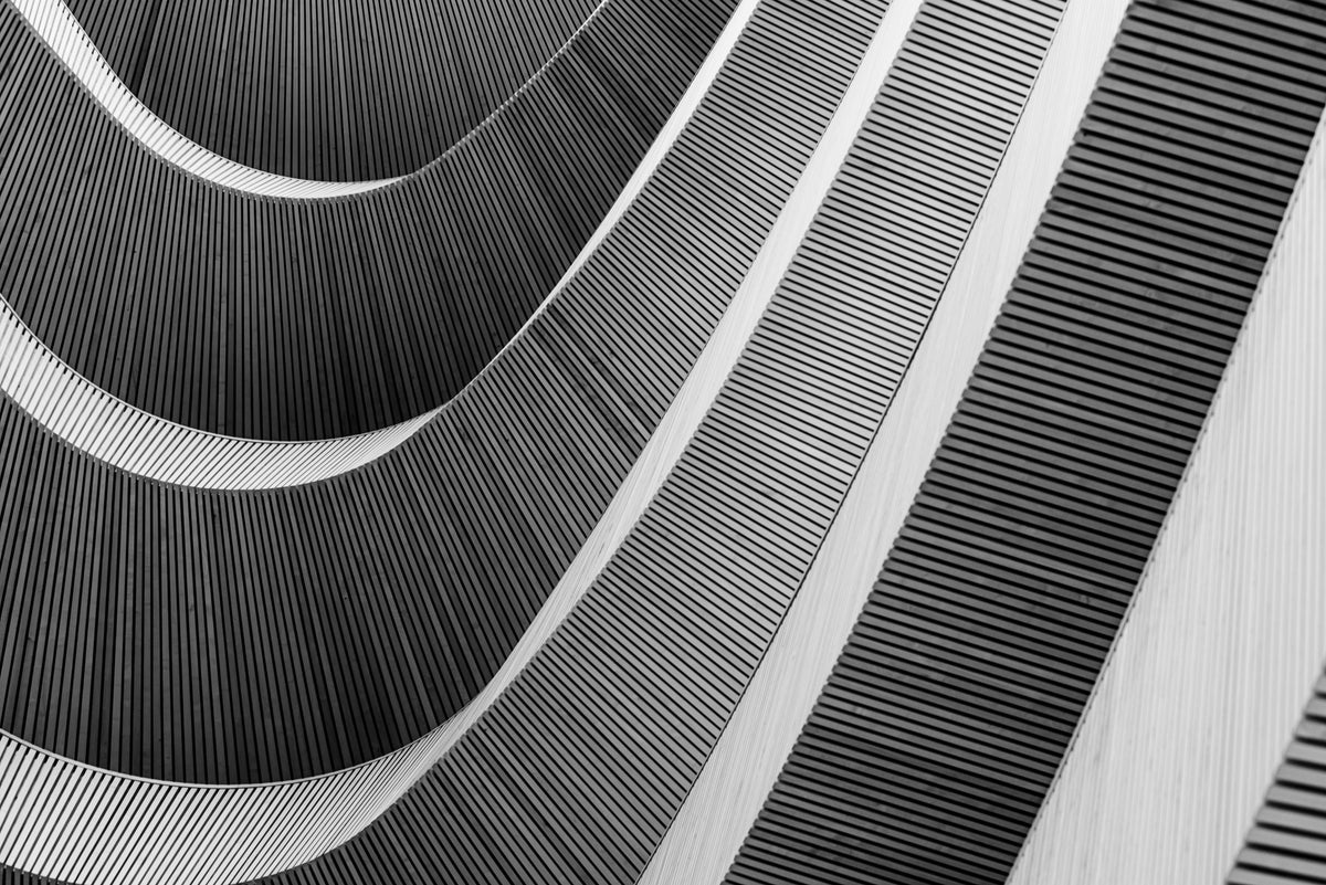 photo-wallpaper-curved-wooden-slats-sweeping-across-a-facade-in-black-and-white