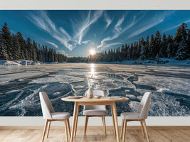 photo-wallpaper-frozen-lake-with-sunburst-over-snowy-conifer-forest