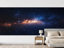 photo-wallpaper-glowing-galaxy-band-in-amber-and-deep-blue-among-countless-stars